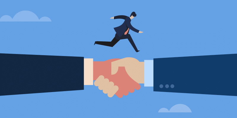 A person in business attire runs confidently across an enormous handshake bridging a gap, symbolizing partnership and collaboration. The backdrop features a blue sky with scattered clouds, adding a sense of openness and opportunity.