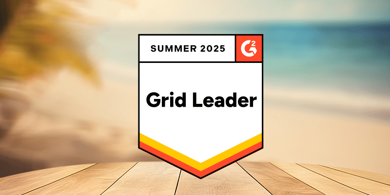 A digital badge featuring the text "Grid Leader, G2 Summer 2025, BetterCloud" centered on a transparent overlay, set against a blurred backdrop of a sandy beach and gentle ocean waves with a wooden table in the foreground.
