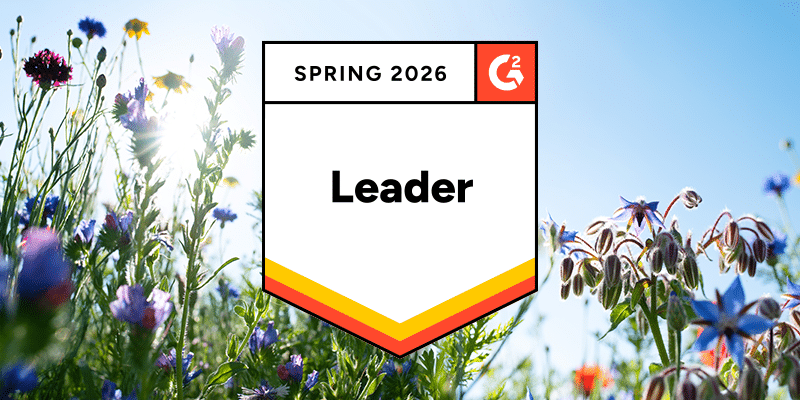 A "Spring 2026 G2 Leader" badge appears in the foreground, set against colorful wildflowers and a vivid blue sky background.